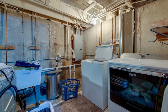 clothes washing area with washer and dryer, sink, and electric panel