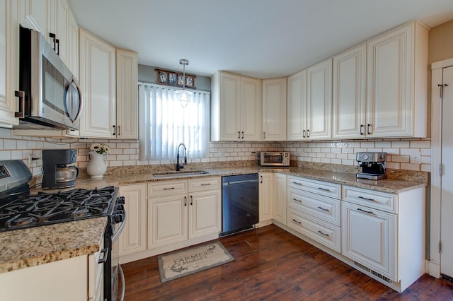 kitchen featuring sink, decorative light fixtures, tasteful backsplash, dark hardwood / wood-style flooring, and appliances with stainless steel finishes