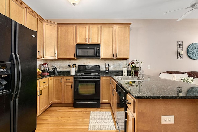 kitchen featuring black appliances, tasteful backsplash, sink, kitchen peninsula, and light wood-type flooring