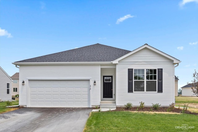 view of front of house featuring a front yard and a garage