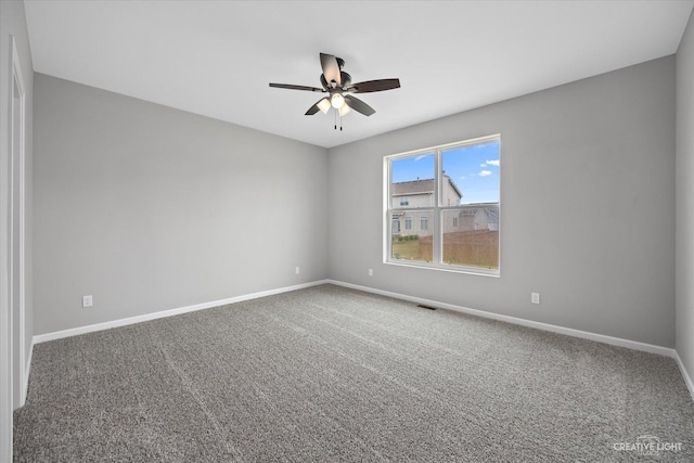 unfurnished room featuring ceiling fan and carpet floors