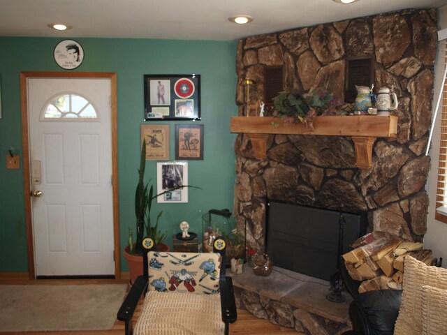 living room with wood-type flooring and a fireplace