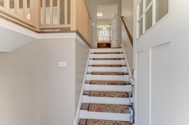 stairs featuring a towering ceiling