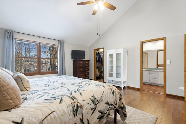 bedroom featuring dark wood-type flooring, a spacious closet, ensuite bathroom, a closet, and ceiling fan