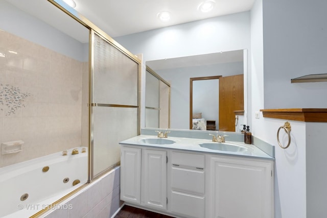 bathroom with bath / shower combo with glass door and vanity