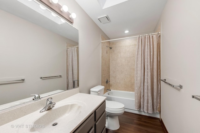 full bathroom with toilet, shower / tub combo, hardwood / wood-style floors, and vanity