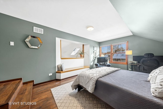 bedroom featuring dark hardwood / wood-style flooring and lofted ceiling