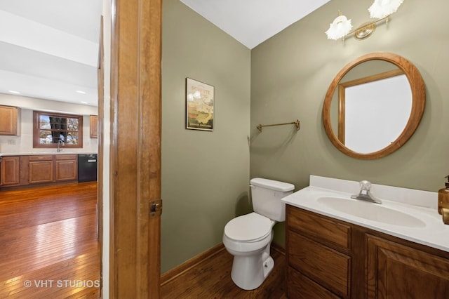 bathroom featuring hardwood / wood-style floors, vanity, and toilet