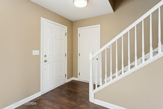 foyer entrance featuring dark wood-type flooring