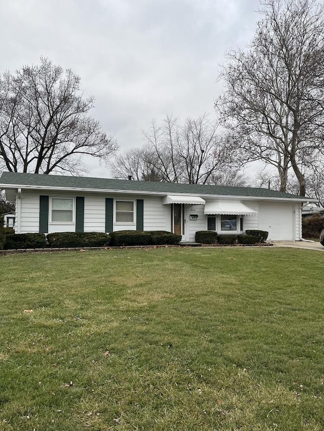 ranch-style home featuring a garage and a front lawn