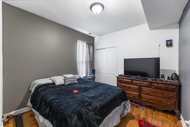 bedroom featuring a closet and light hardwood / wood-style flooring