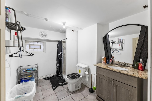 bathroom with toilet, a shower with curtain, tile patterned floors, and vanity