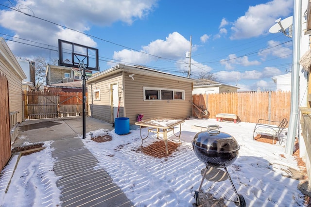 snow covered patio featuring an outdoor structure