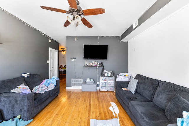 living room with wood-type flooring and ceiling fan