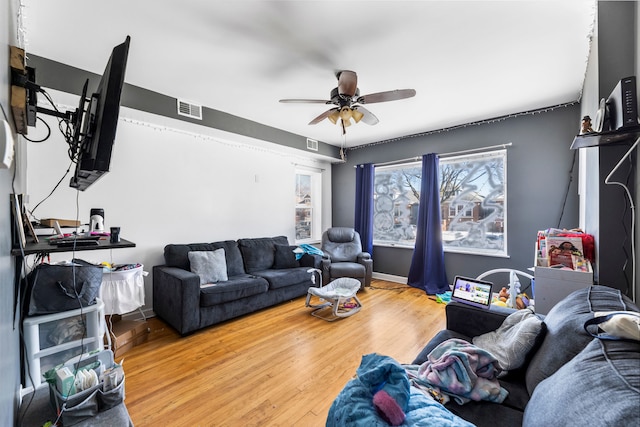 living room with hardwood / wood-style flooring, ceiling fan, and a healthy amount of sunlight