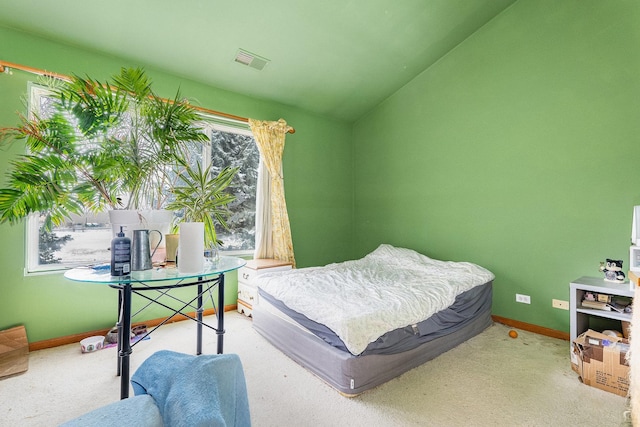 carpeted bedroom with lofted ceiling