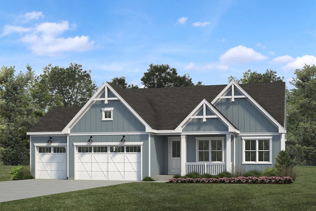 view of front facade featuring a front yard, a garage, and a porch