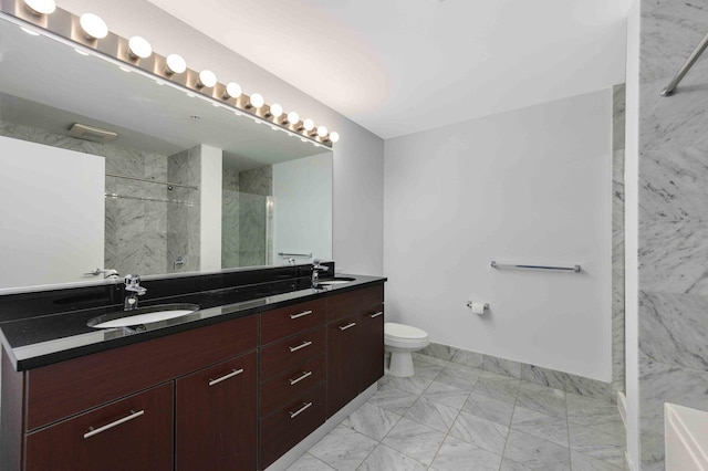 full bath featuring toilet, a sink, marble finish floor, a marble finish shower, and double vanity