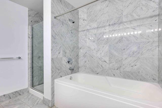 bathroom with marble finish floor, a shower stall, and a bath