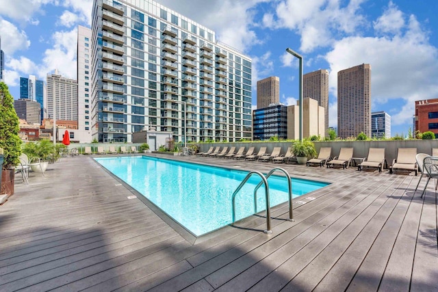 pool featuring a city view and a wooden deck