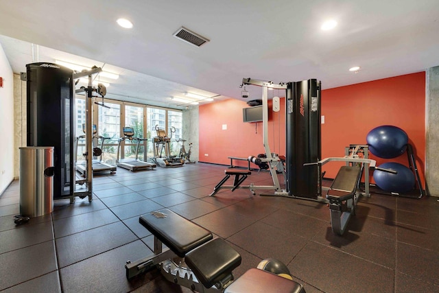 workout area with visible vents, a wall of windows, and recessed lighting