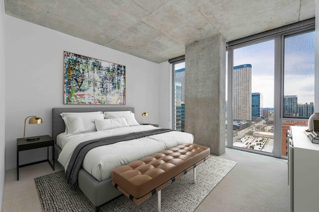 bedroom featuring carpet floors, access to outside, floor to ceiling windows, and a city view