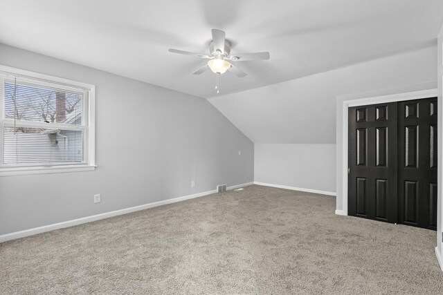 additional living space featuring lofted ceiling, carpet floors, and ceiling fan