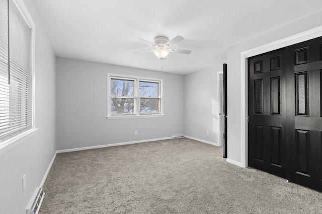unfurnished bedroom with carpet, baseboards, a closet, and a ceiling fan