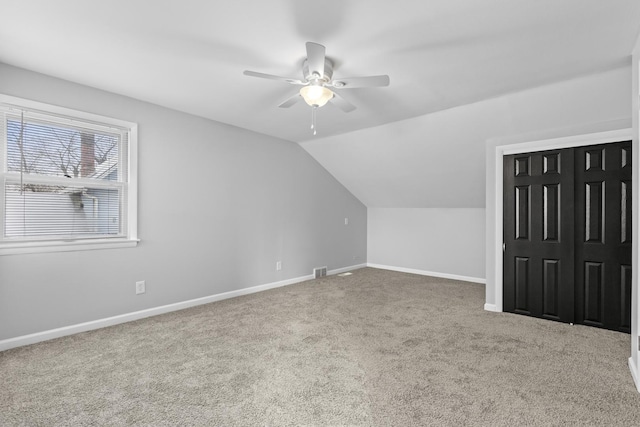 bonus room with a ceiling fan, carpet, lofted ceiling, and baseboards