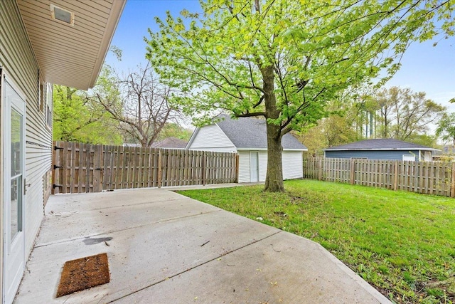 view of yard with a patio area and an outbuilding
