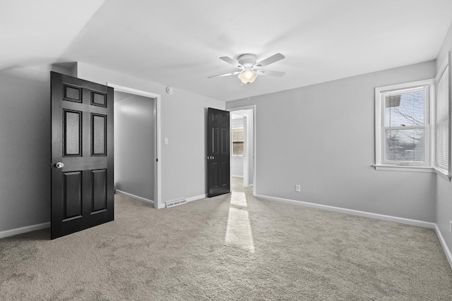 unfurnished bedroom featuring carpet floors and ceiling fan