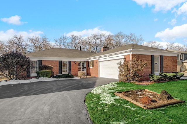 single story home featuring a garage and a front yard