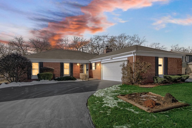 view of front of home featuring a garage and a lawn