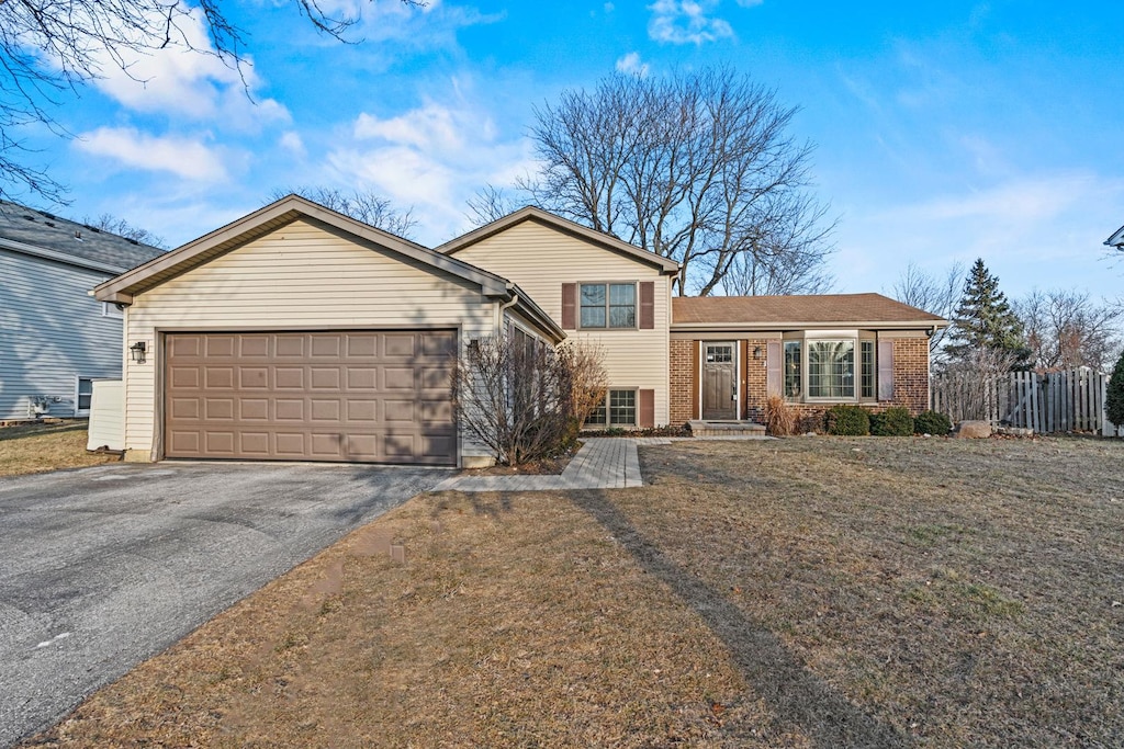 view of front of home with a garage and a front yard