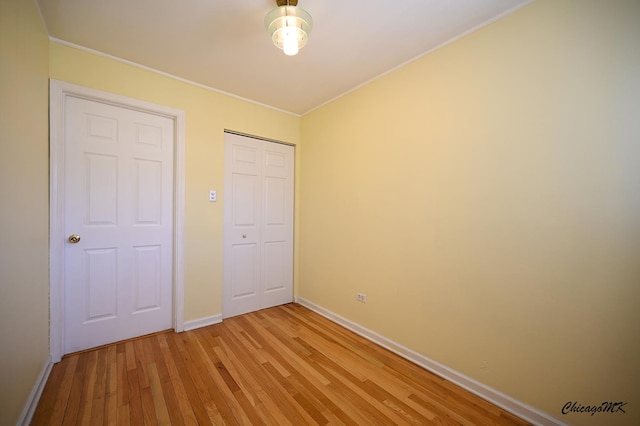 unfurnished bedroom featuring light hardwood / wood-style floors and a closet