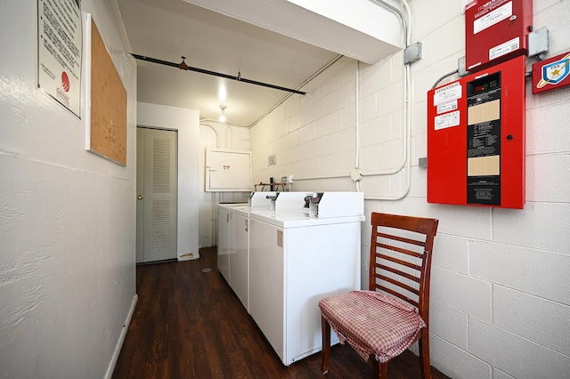 clothes washing area with separate washer and dryer and dark hardwood / wood-style floors