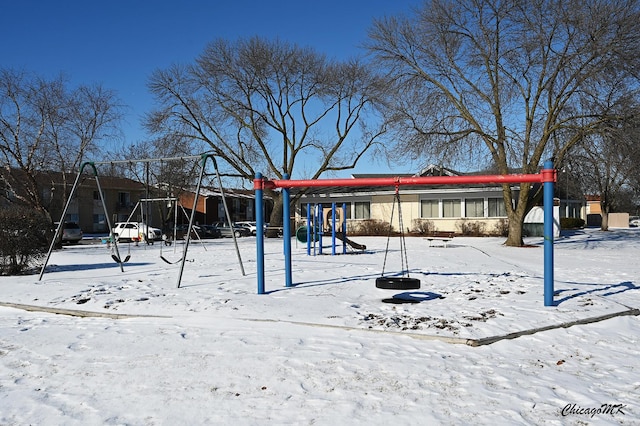 snowy yard with a playground