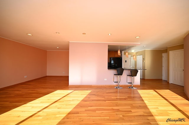 unfurnished living room with light hardwood / wood-style flooring