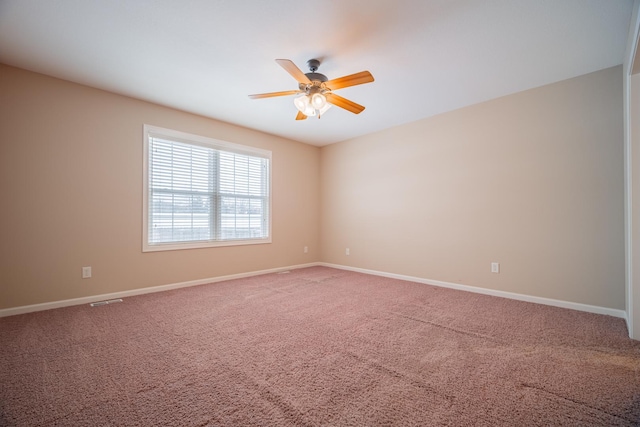 empty room with ceiling fan and carpet