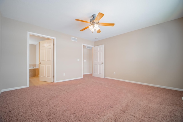 unfurnished bedroom featuring ensuite bath, light carpet, and ceiling fan