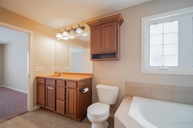 bathroom with tiled bath, tile patterned flooring, a healthy amount of sunlight, and vanity