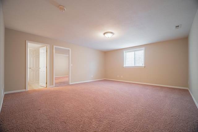 unfurnished room with light colored carpet