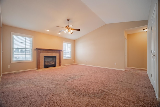 unfurnished living room featuring carpet flooring, a fireplace, ceiling fan, and vaulted ceiling