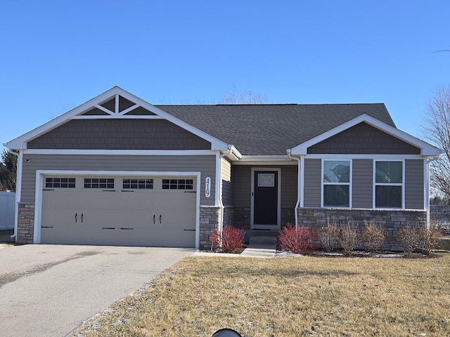 craftsman-style house with a front yard and a garage