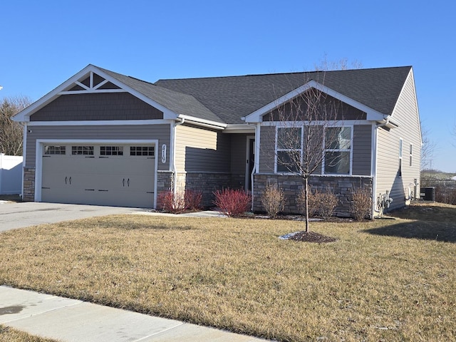 view of front of home with a garage, central air condition unit, and a front lawn