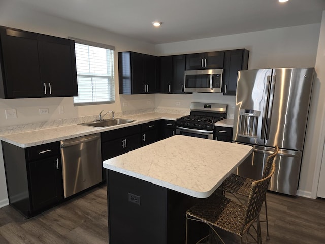 kitchen featuring sink, dark hardwood / wood-style flooring, a center island, and appliances with stainless steel finishes