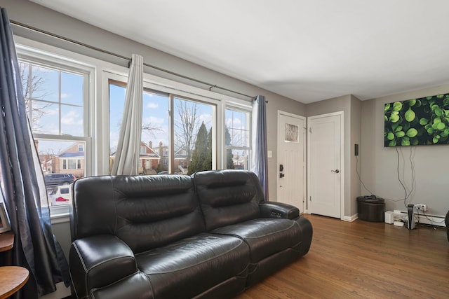 living room with baseboard heating and dark hardwood / wood-style flooring