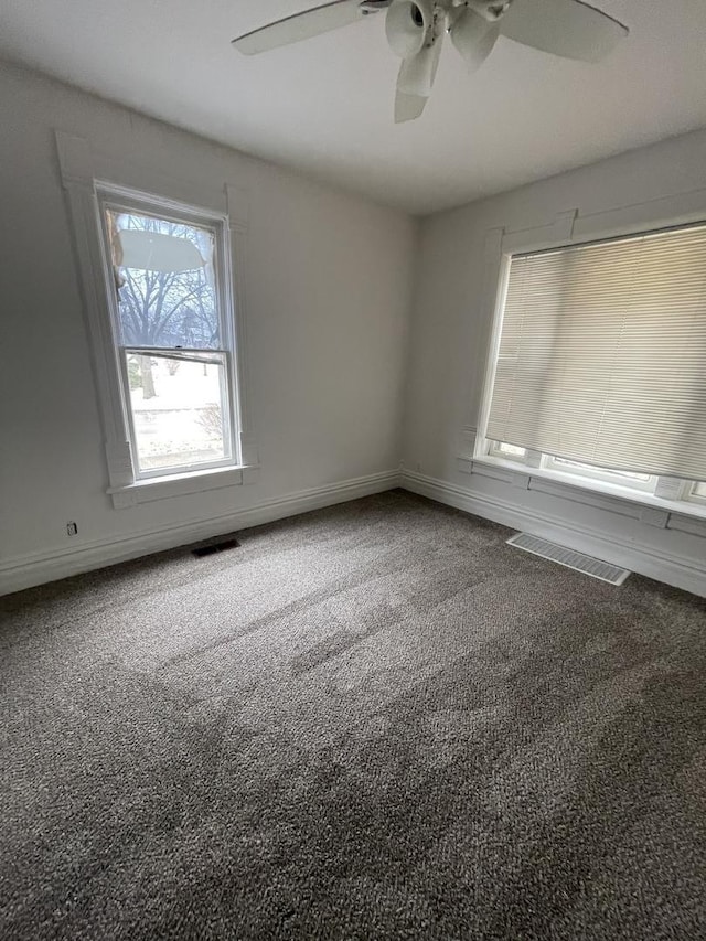 empty room featuring ceiling fan and carpet flooring