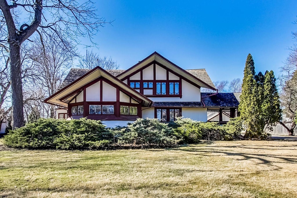 rear view of property featuring a yard