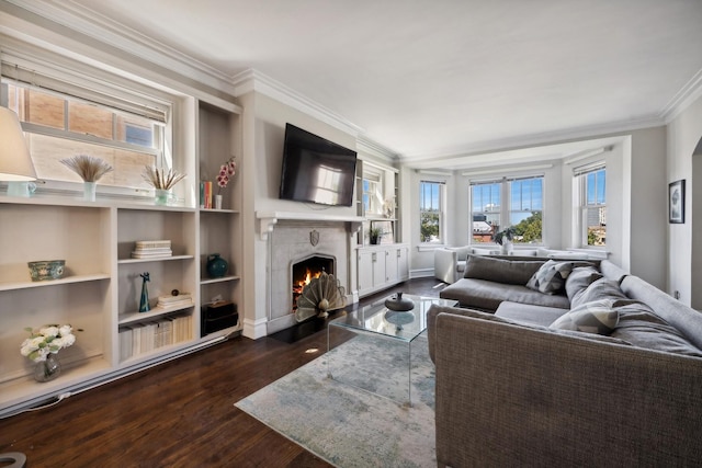 living room featuring dark hardwood / wood-style flooring, crown molding, and built in features